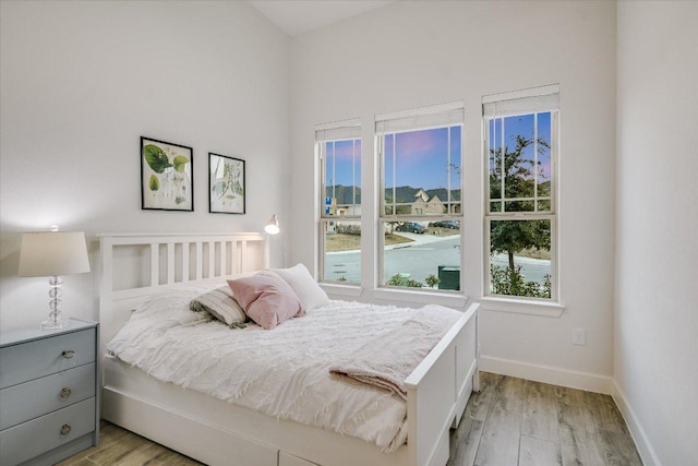 bedroom featuring light wood-type flooring and baseboards