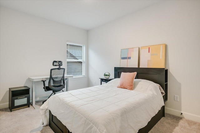 bedroom featuring light colored carpet and baseboards