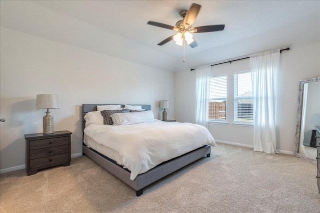 carpeted bedroom with baseboards and a ceiling fan