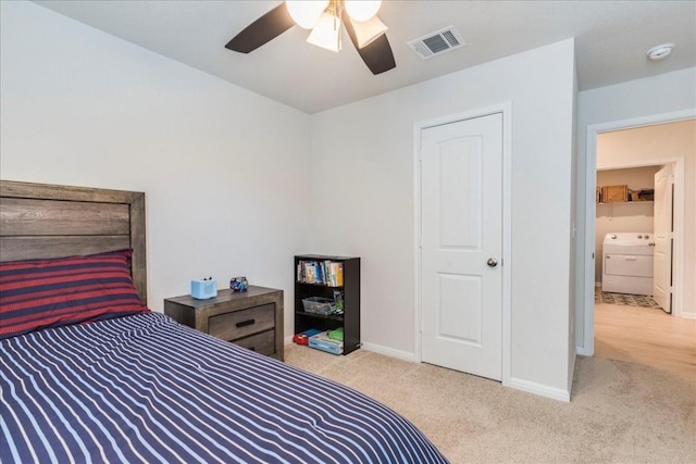 bedroom featuring washer / clothes dryer, carpet floors, baseboards, and a ceiling fan