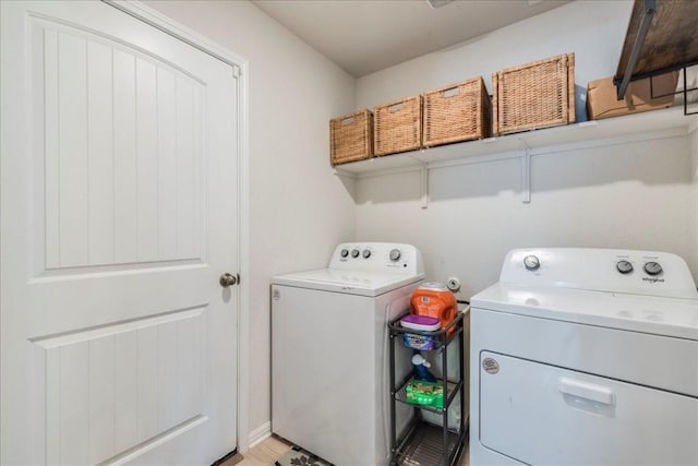 clothes washing area featuring independent washer and dryer