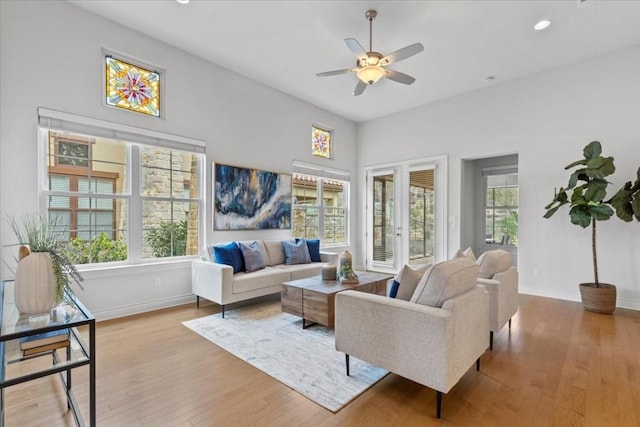 living room with light wood-style floors, recessed lighting, baseboards, and a ceiling fan