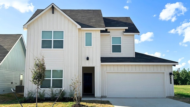 view of front of property featuring a garage, driveway, board and batten siding, and cooling unit