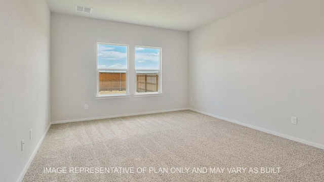 carpeted spare room with visible vents and baseboards