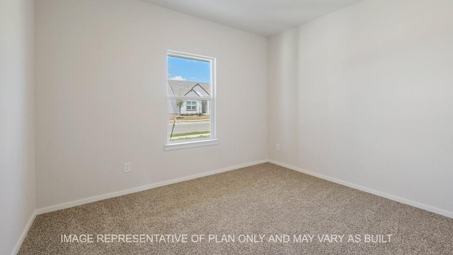 spare room featuring carpet flooring and baseboards