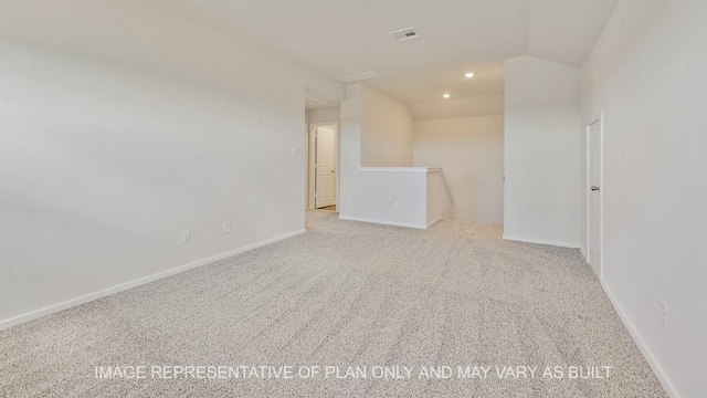 unfurnished room featuring recessed lighting, light colored carpet, visible vents, vaulted ceiling, and baseboards