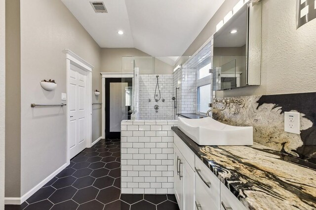 6303 Needham Ln, Austin, TX 78739 - full bathroom featuring vanity, vaulted ceiling, walk in shower, tile patterned floors, and recessed lighting