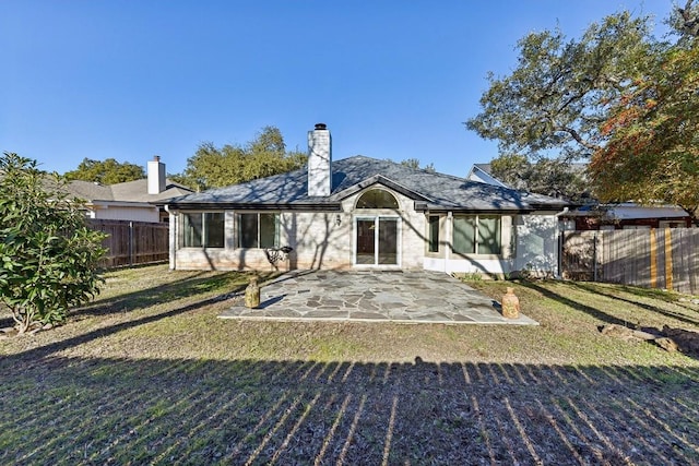 6303 Needham Ln, Austin, TX 78739 - back of property with a patio and a chimney