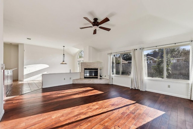 6303 Needham Ln, Austin, TX 78739 - unfurnished living room featuring lofted ceiling, a ceiling fan, hardwood / wood-style flooring, a glass covered fireplace, and baseboards