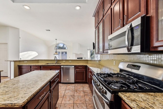 6303 Needham Ln, Austin, TX 78739 - kitchen featuring stainless steel appliances, a sink, vaulted ceiling, tasteful backsplash, and light stone counters
