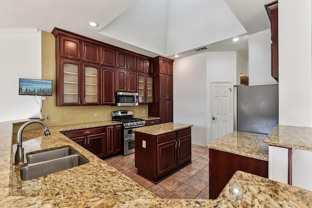 6303 Needham Ln, Austin, TX 78739 - kitchen featuring stainless steel appliances, a sink, decorative backsplash, light stone countertops, and recessed lighting
