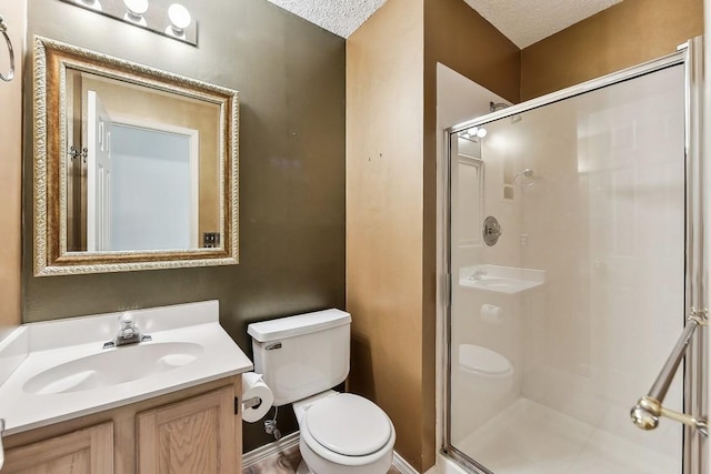 6303 Needham Ln, Austin, TX 78739 - bathroom with toilet, a stall shower, vanity, and a textured ceiling