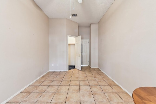 6303 Needham Ln, Austin, TX 78739 - unfurnished room with a ceiling fan, baseboards, a textured ceiling, and light tile patterned flooring