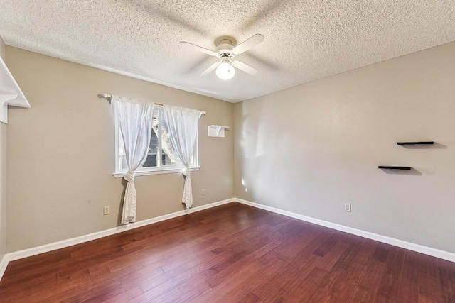 6303 Needham Ln, Austin, TX 78739 - empty room with a ceiling fan, wood finished floors, a textured ceiling, and baseboards