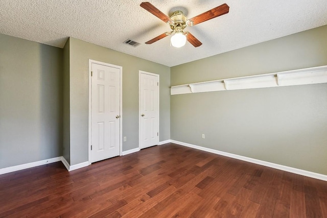 6303 Needham Ln, Austin, TX 78739 - unfurnished bedroom with baseboards, wood finished floors, a ceiling fan, and a textured ceiling