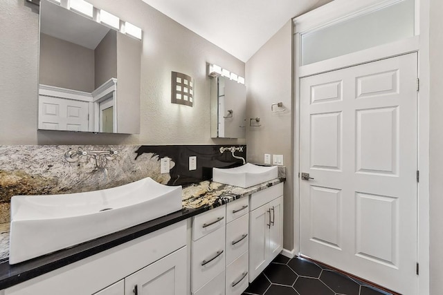 6303 Needham Ln, Austin, TX 78739 - bathroom with double vanity, tile patterned flooring, and vaulted ceiling