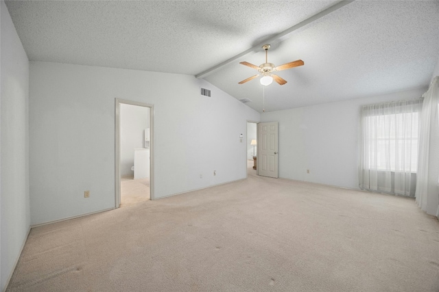 unfurnished room with visible vents, lofted ceiling with beams, light carpet, ceiling fan, and a textured ceiling