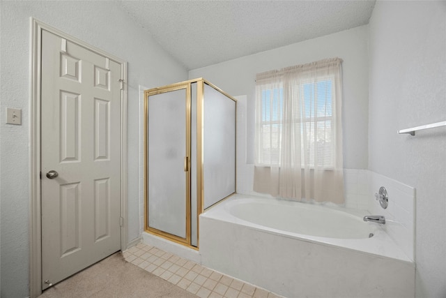 full bath featuring a bath, a stall shower, and a textured ceiling