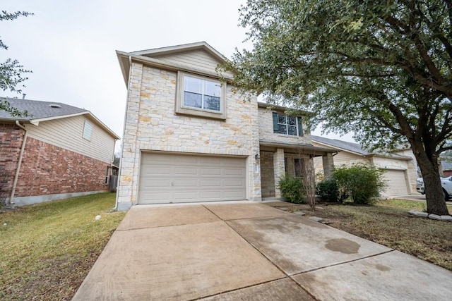 traditional-style house with stone siding, an attached garage, driveway, and a front yard