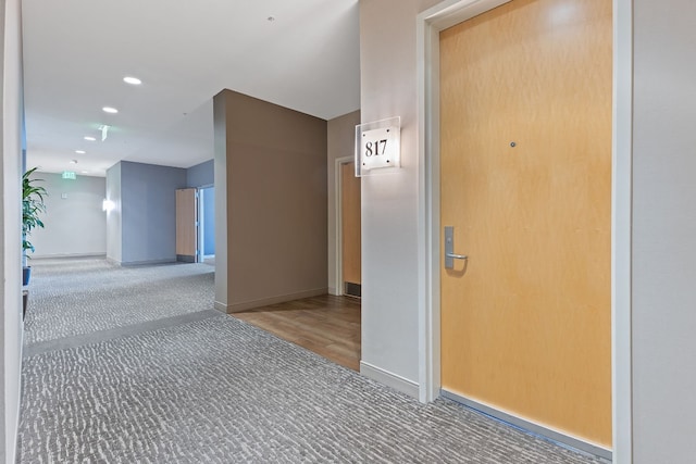 hallway featuring recessed lighting, baseboards, and carpet floors