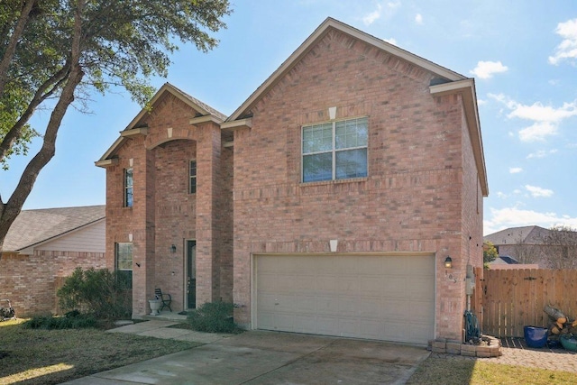 traditional home featuring a garage, concrete driveway, brick siding, and fence