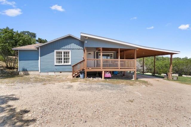 rear view of property featuring crawl space and driveway