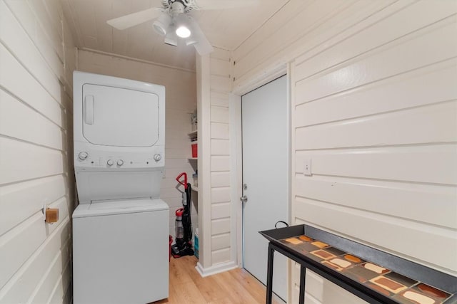 15001 Dexler Dr, Austin, TX 78734 - washroom featuring stacked washing machine and dryer, light wood-style flooring, and a ceiling fan