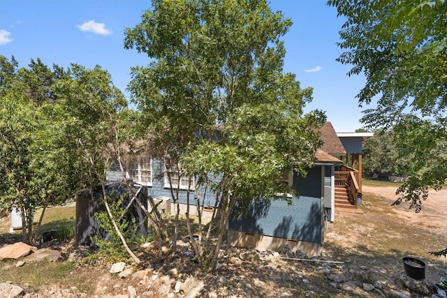15001 Dexler Dr, Austin, TX 78734 - view of home's exterior with stairway and a wooden deck