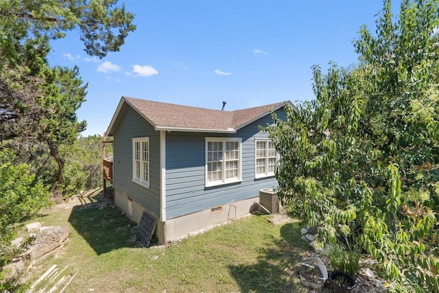 15001 Dexler Dr, Austin, TX 78734 - view of side of property featuring a lawn and a central AC unit
