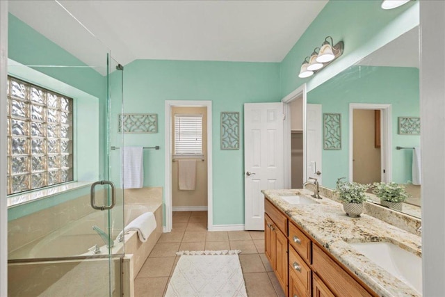 full bath with a bath, lofted ceiling, tile patterned flooring, a shower stall, and a sink