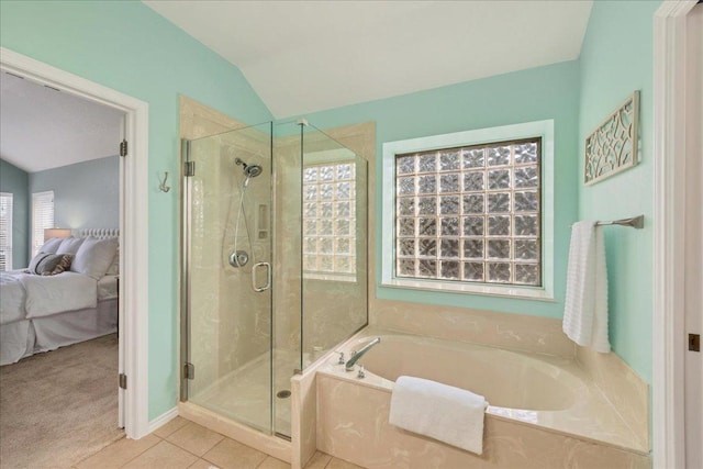 ensuite bathroom with ensuite bathroom, tile patterned flooring, a bath, and a shower stall