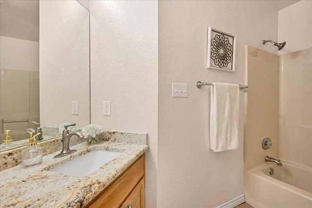 bathroom with bathtub / shower combination and vanity