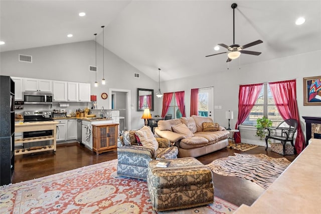 living room featuring visible vents, high vaulted ceiling, ceiling fan, and recessed lighting