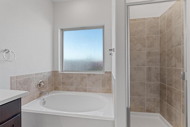 full bath featuring a shower stall, a bath, and vanity