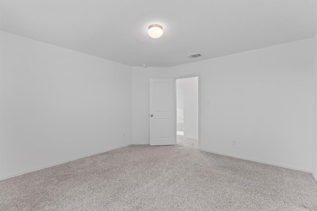 empty room featuring carpet and visible vents