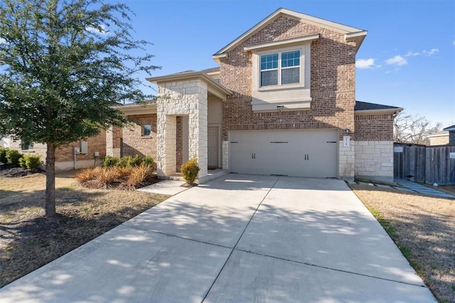 traditional-style house with a garage, stone siding, brick siding, and concrete driveway