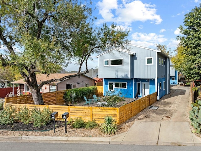 view of front facade with a fenced front yard and board and batten siding