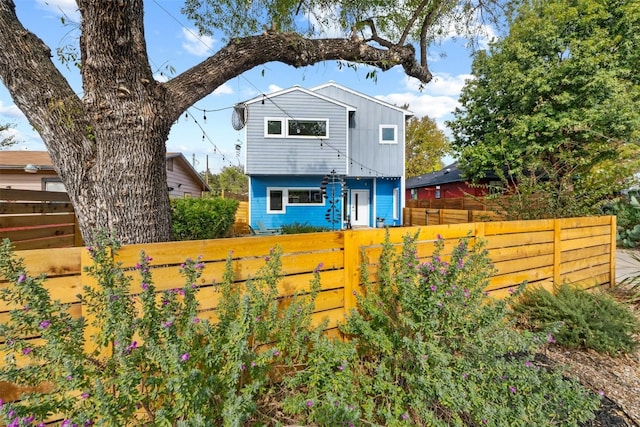 exterior space featuring board and batten siding and fence private yard