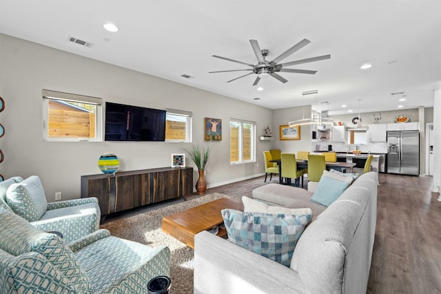 living room featuring baseboards, wood finished floors, visible vents, and recessed lighting