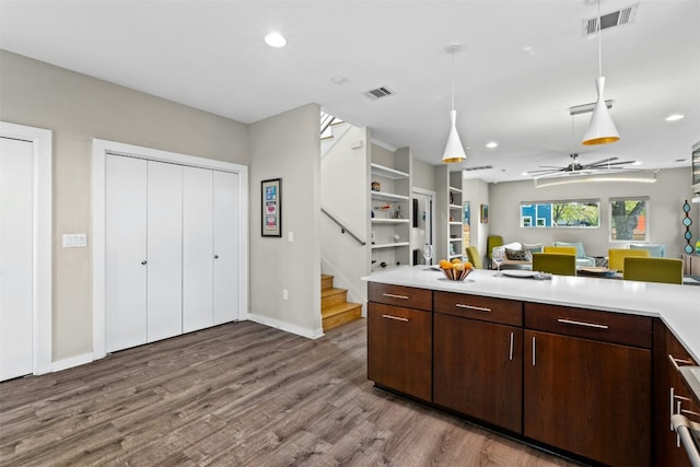 kitchen with light countertops, visible vents, and wood finished floors