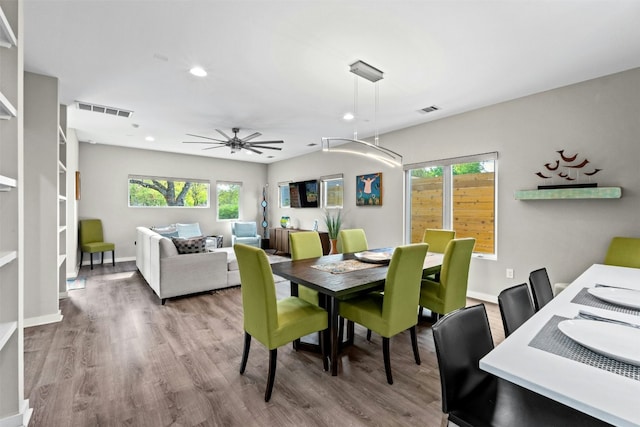 dining room featuring a ceiling fan, visible vents, baseboards, and wood finished floors