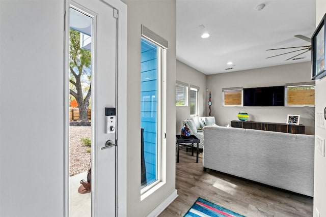 doorway featuring wood finished floors, a ceiling fan, and recessed lighting