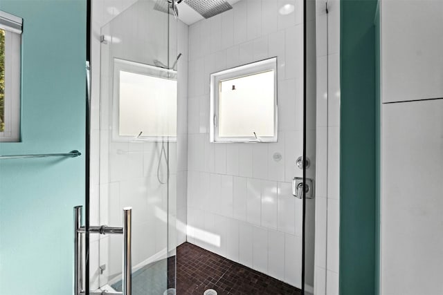 bathroom featuring a stall shower and a wealth of natural light