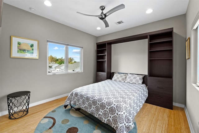 bedroom featuring recessed lighting, wood finished floors, visible vents, and baseboards