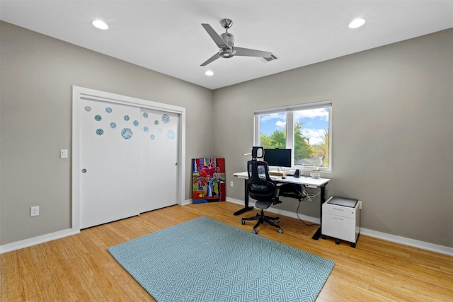 home office with recessed lighting, visible vents, light wood-style flooring, and baseboards