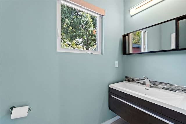 bathroom with vanity and decorative backsplash