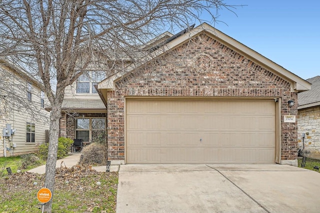 view of front facade featuring a garage, brick siding, and driveway