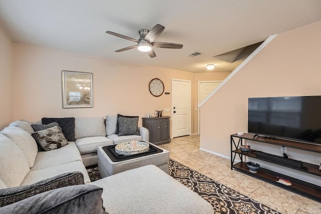 living room with light tile patterned floors, ceiling fan, visible vents, and baseboards