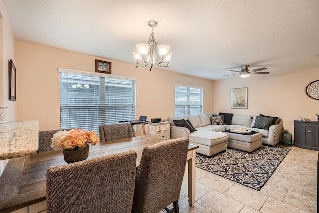 dining room featuring ceiling fan with notable chandelier