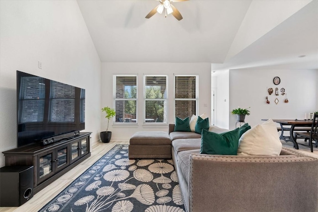 living area featuring lofted ceiling and ceiling fan